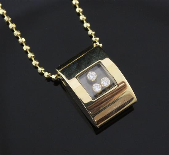 An 18ct gold and diamond pendant on a facetted ball link chain, chain 17in.